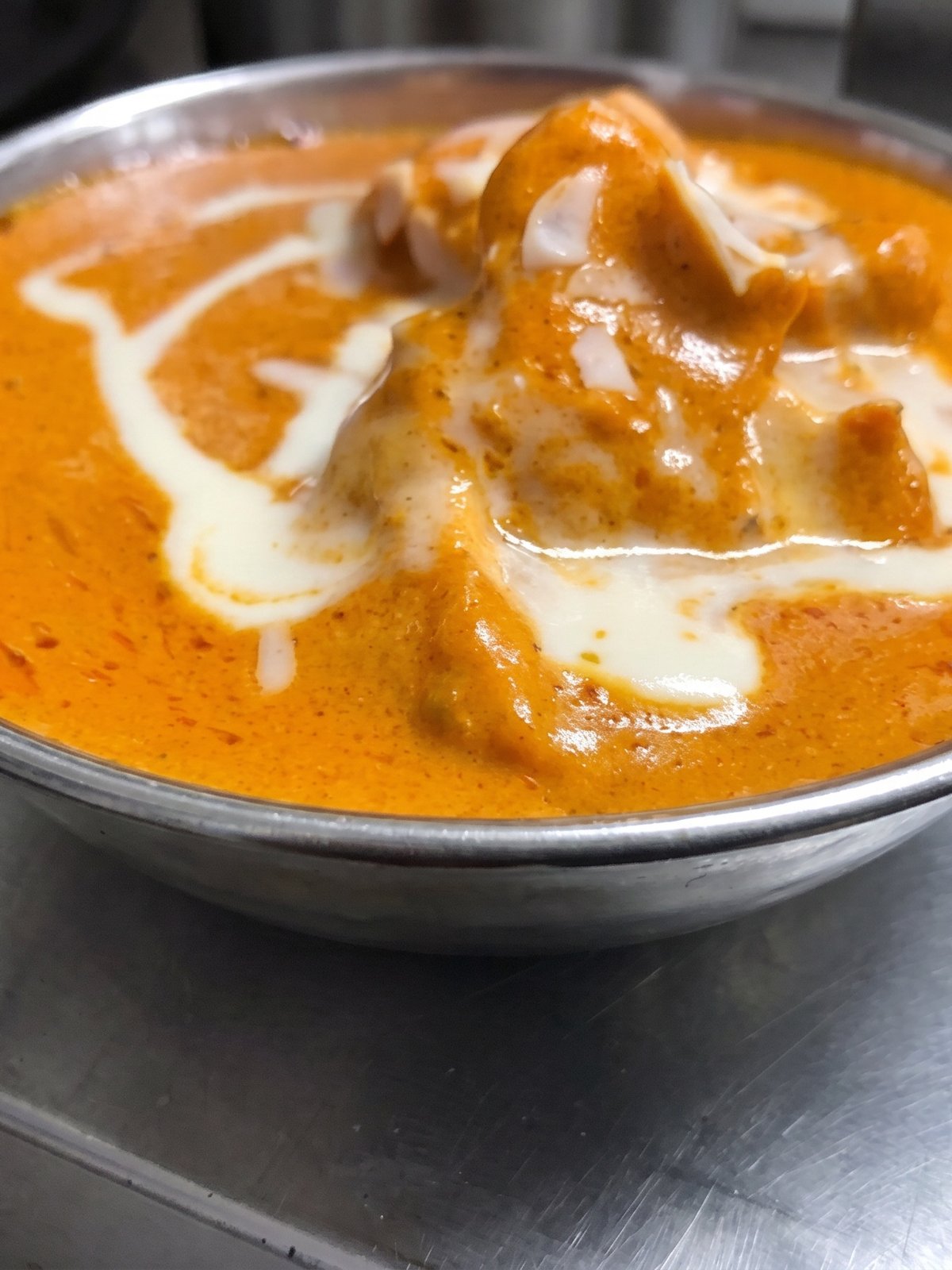 After: rich studio menu photo of the same butter chicken with glossy sauce, deep colour and dimension