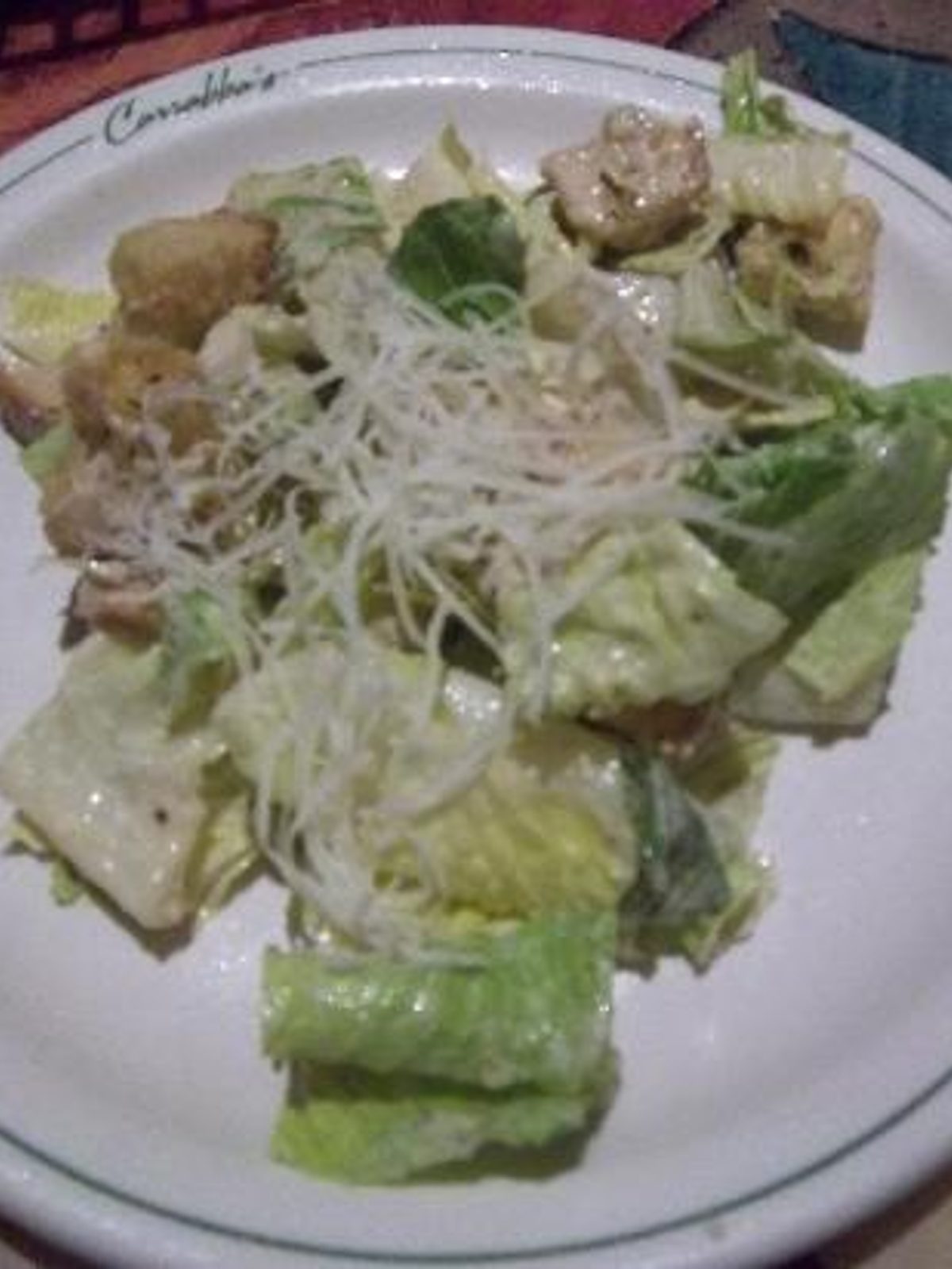 Before: dull phone photo of a caesar salad in a bowl under flat kitchen lighting