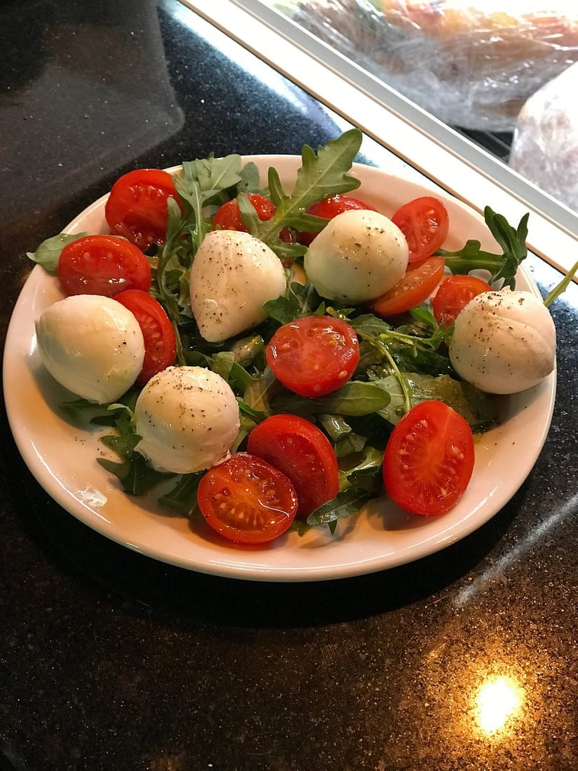 Before: dim phone photo of a caprese salad with mozzarella and tomatoes on a kitchen counter