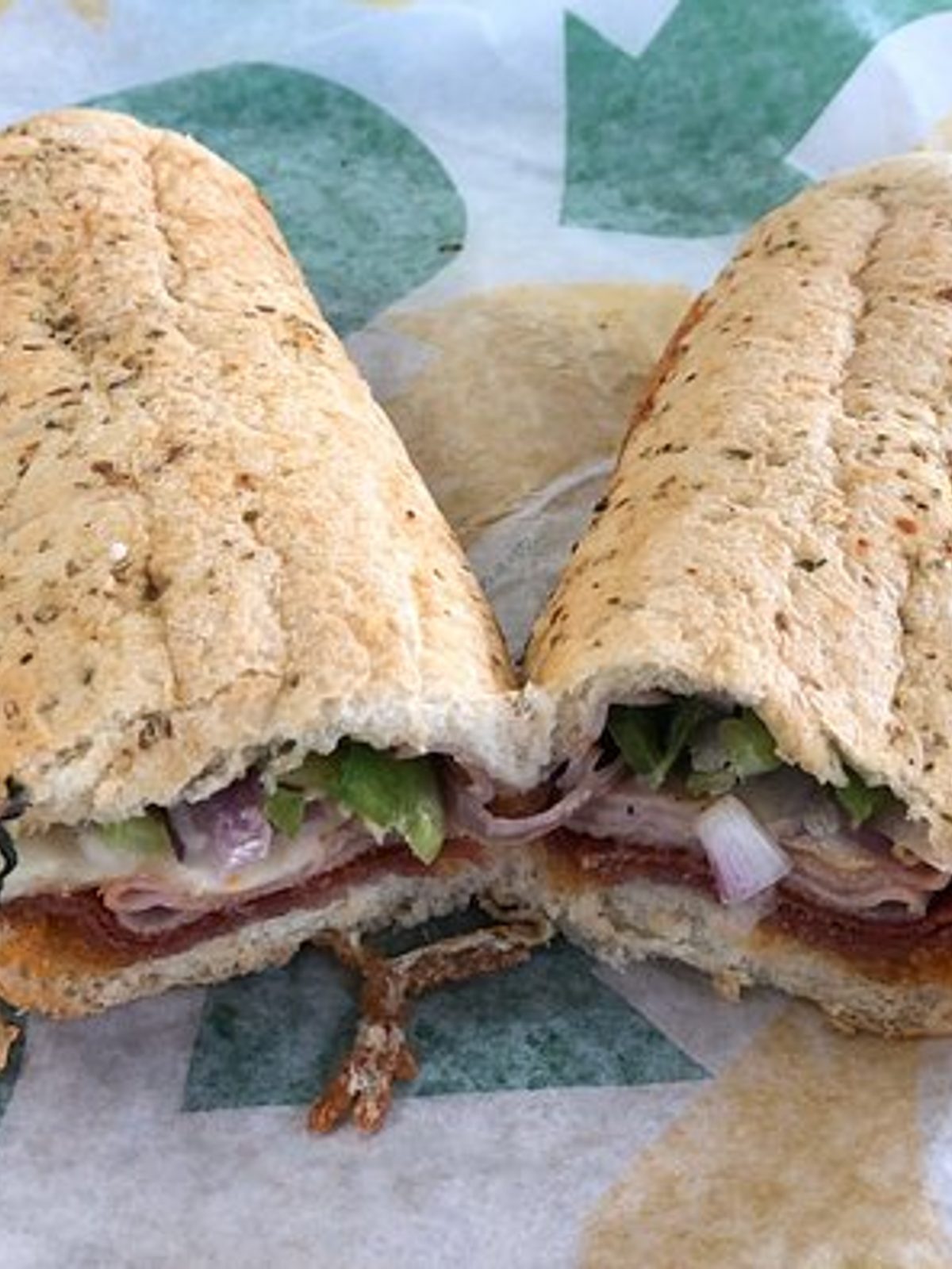 Before: dim phone photo of a cut sandwich on a café counter under flat overhead light