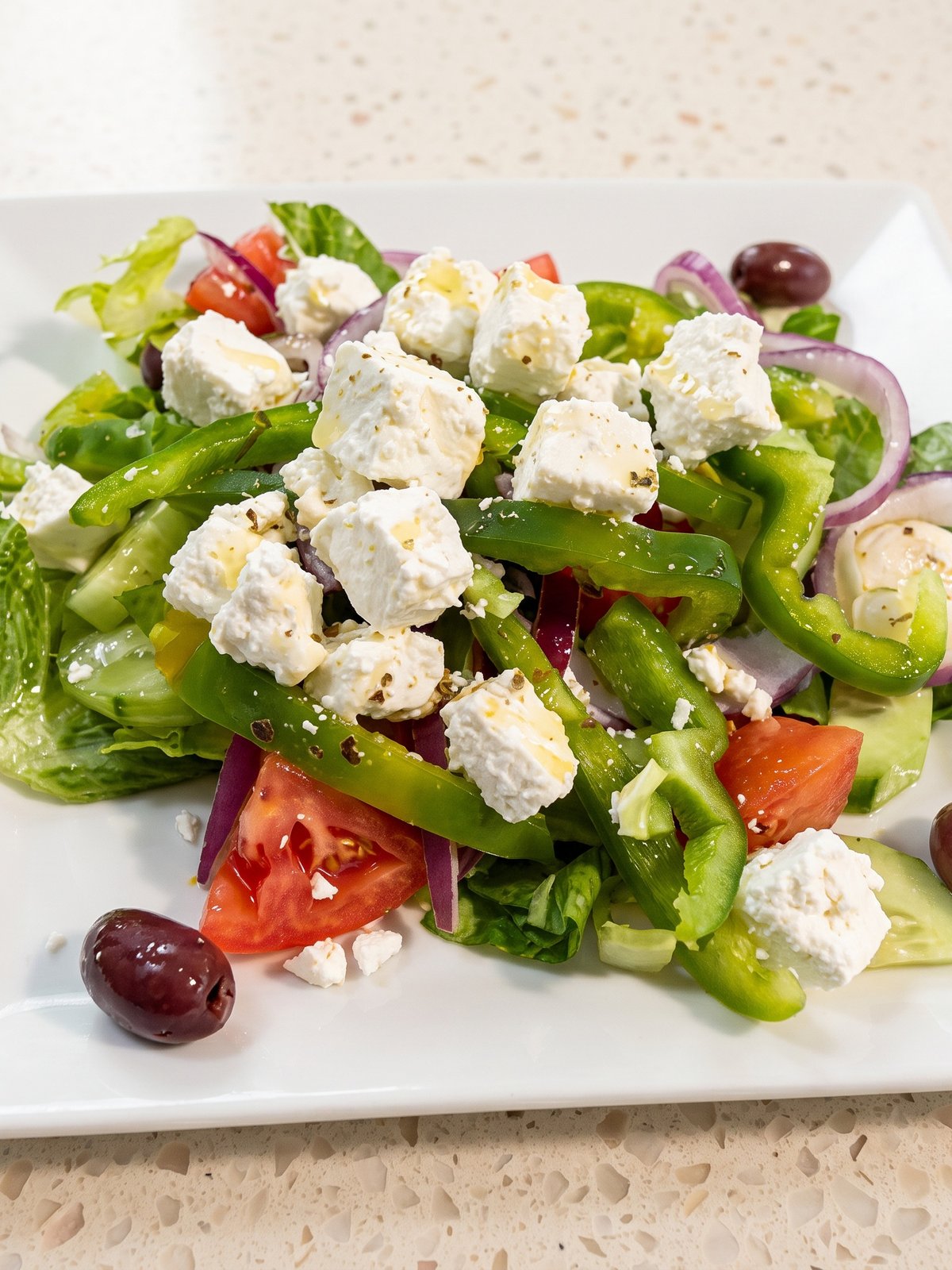 After: bright, clean menu photo of the same dishes with true whites and fresh Mediterranean colour