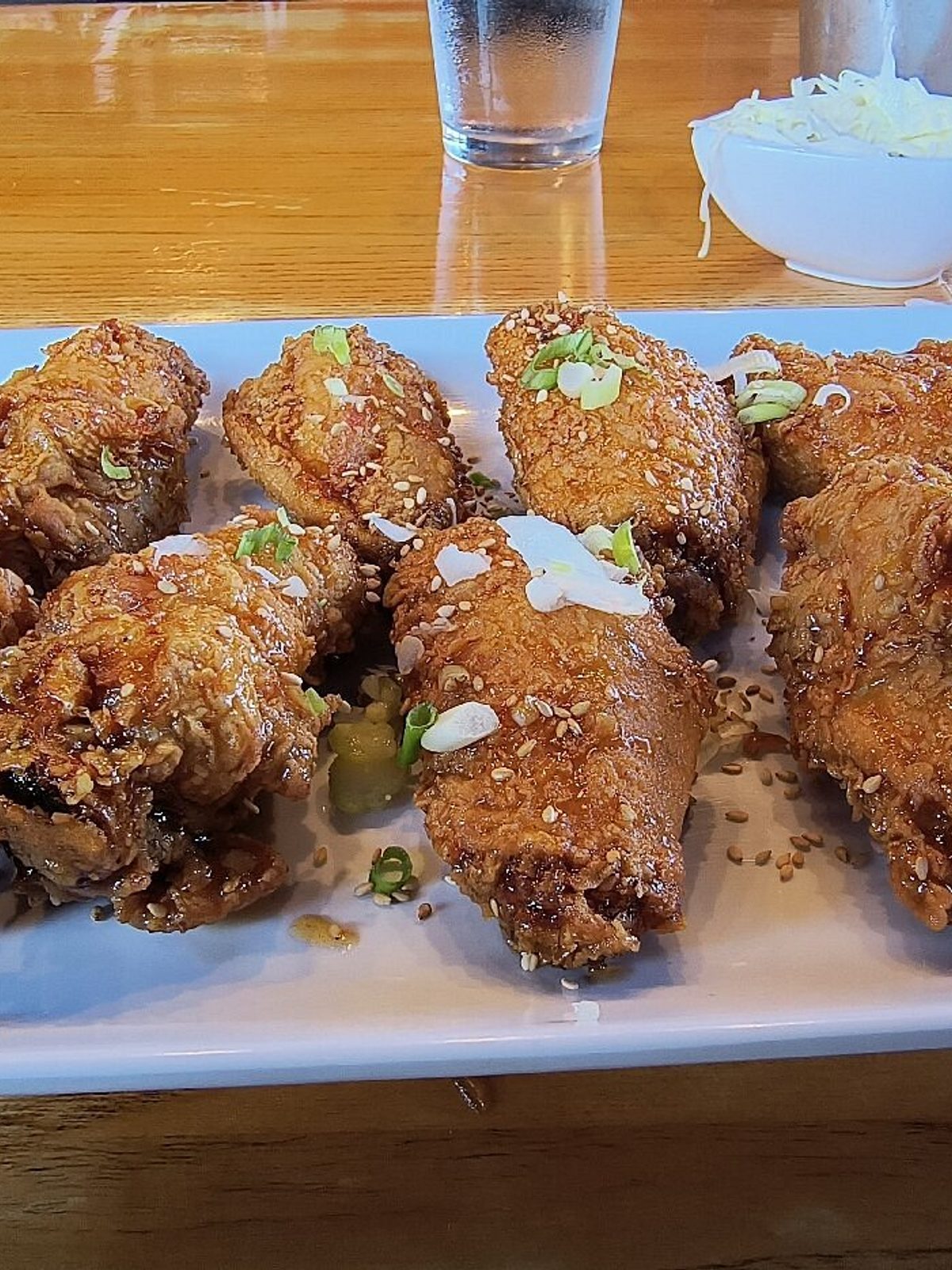 Before: dim phone photo of korean fried chicken and banchan bowls with muddy red sauce tones