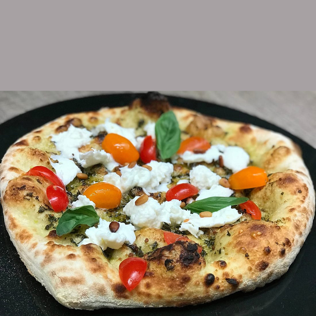 Before: dim phone photo of a margherita pizza with dull matte cheese on a stainless steel prep table