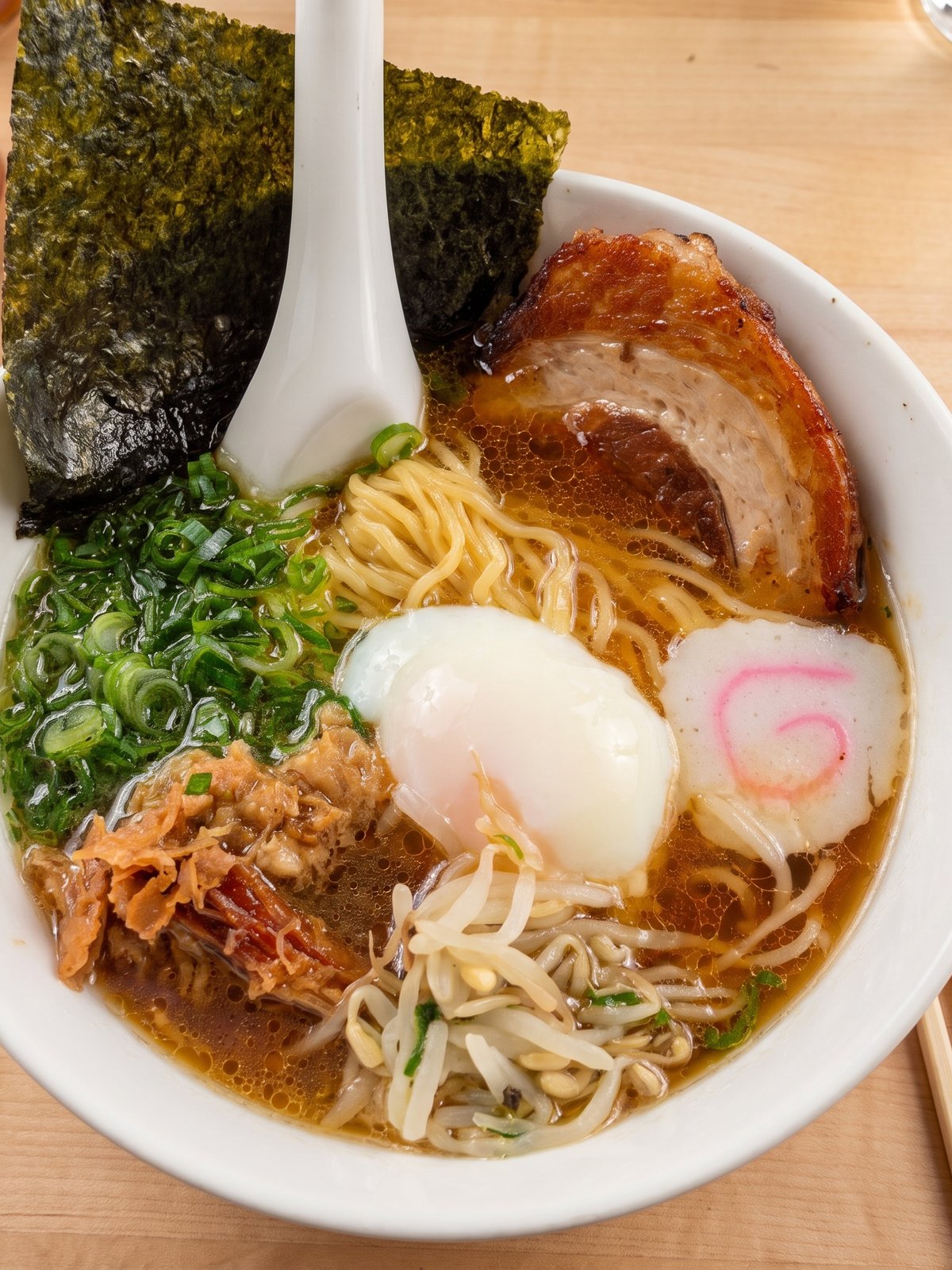 After: studio-lit menu photo of the same bowl of ramen with glossy broth and clearly defined toppings